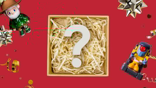 A box full of straw and a question mark surrounded by toys.