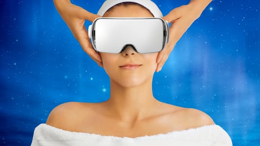 A woman receives a temple massage while wearing a headset. 