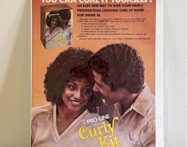 A vintage Pro-Line Curly Kit advertisement featuring a smiling Black couple with Jheri curls, promoting an affordable home perm.