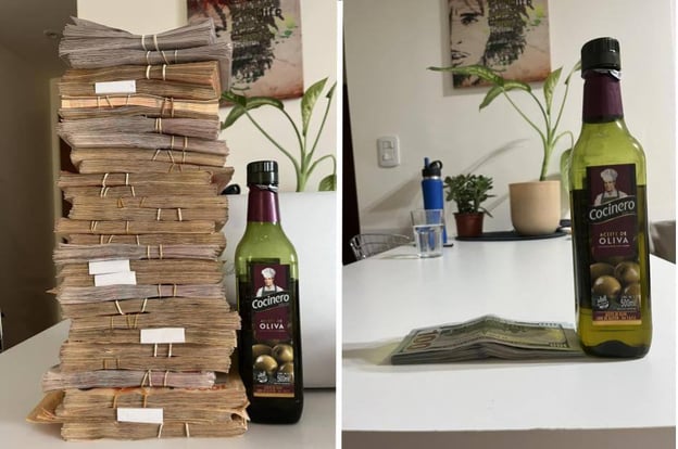 Two sides of a table: one with a tall stack of cash and a "Cocinero" olive oil bottle, the other with the same bottle and a smaller stack of bills. Background features plants and wall art.