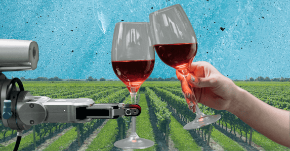 A mechanical arm and a human arm clinking glasses filled with red wine.
