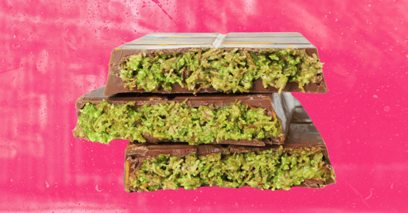 Three pieces of Dubai chocolate against a pink background.