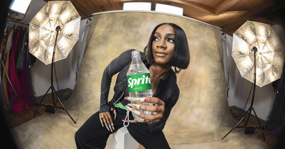 Sha’Carri Richardson holding a bottle of Sprite.